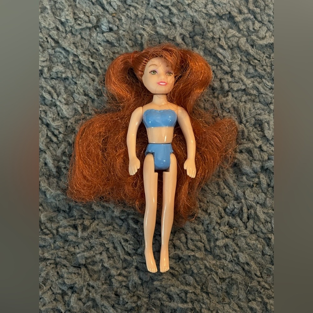 Lightly used Polly pocket with real long auburn pigtails and blue undergarments